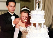 married couple sharing wedding cake