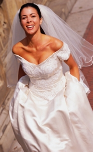 happy bride showing off her wedding gown