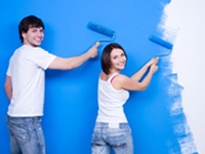 young couple painting their new home
